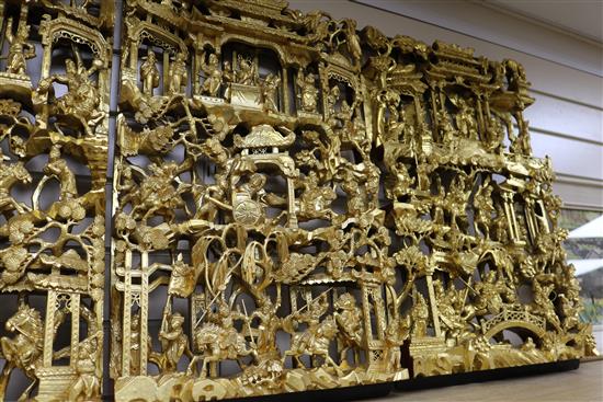 Six Chinese carved giltwood panels of soldiers amid pavilions